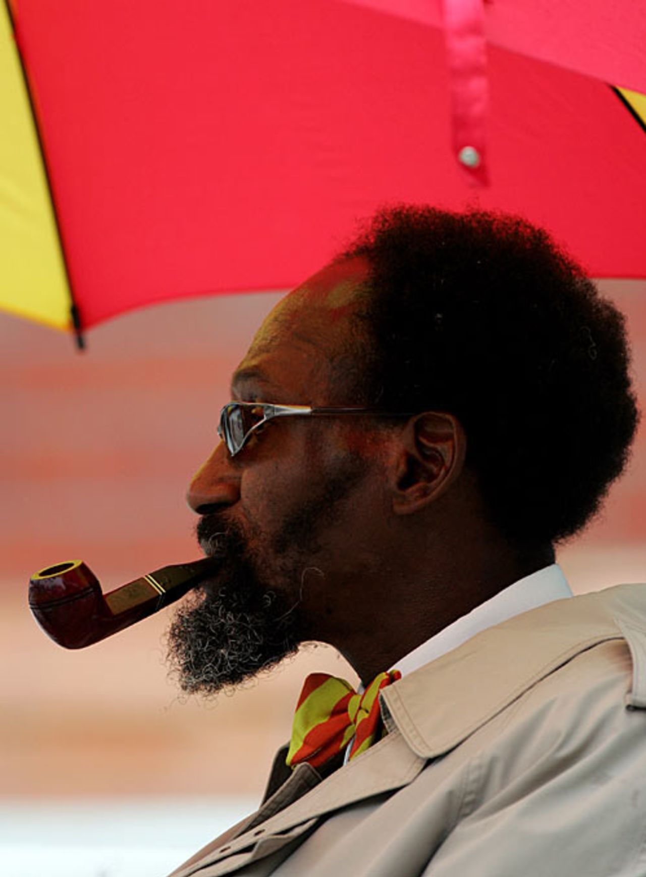 An MCC member shelters under an umbrella and enjoys a pipe at Lord's, England v West Indies, 1st Test, Lord's, May 21, 2007