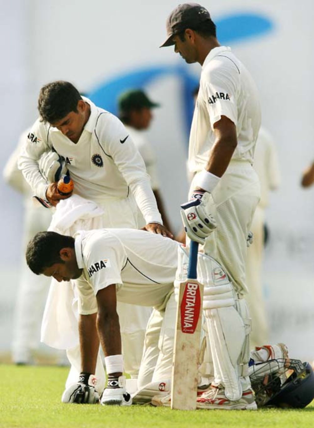 Wasim Jaffer vomits as teammate Rajesh Pawar attends to him and captain Rahul Dravid looks on. Bangladesh v India, 2nd Test, Mirpur, 1st day, May 25, 2007