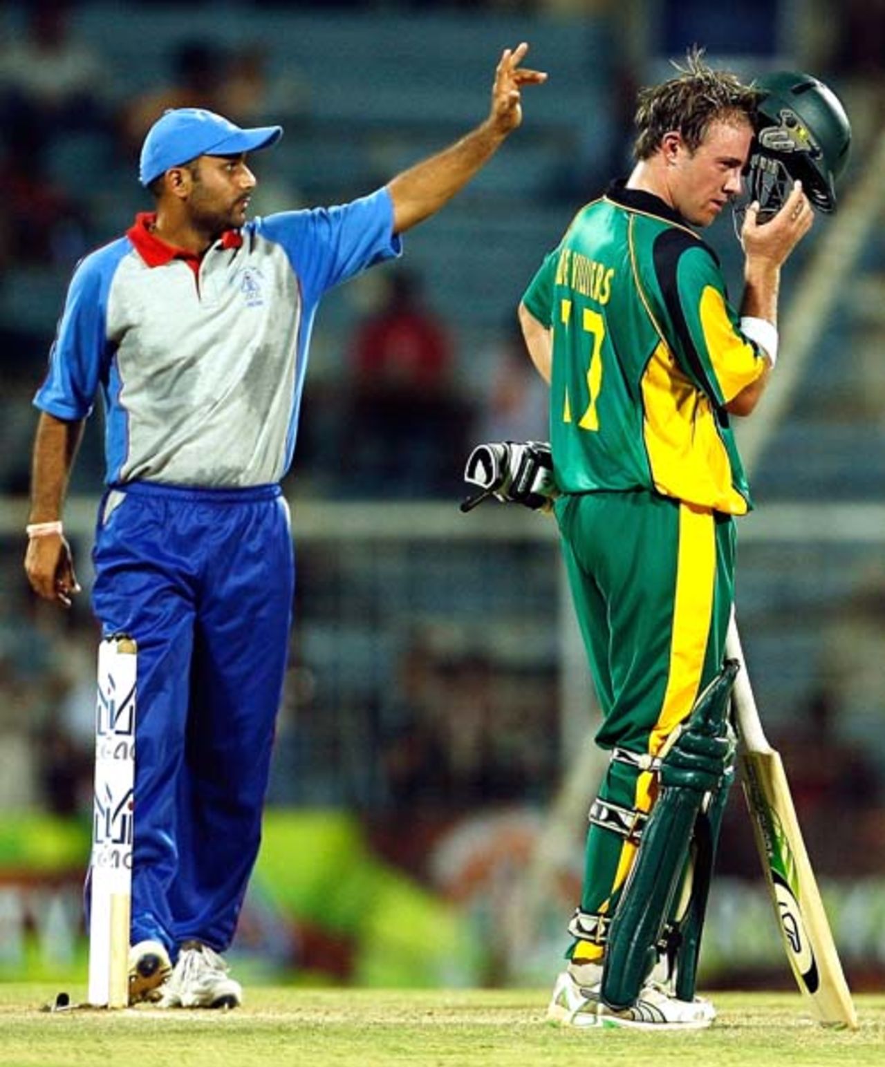 The acting skipper of Asia XI, Virender Sehwag makes a field change as  AB deVilliers looks on during the third ODI of the Afro-Asia Cup at Chennai, June 10, 2007 