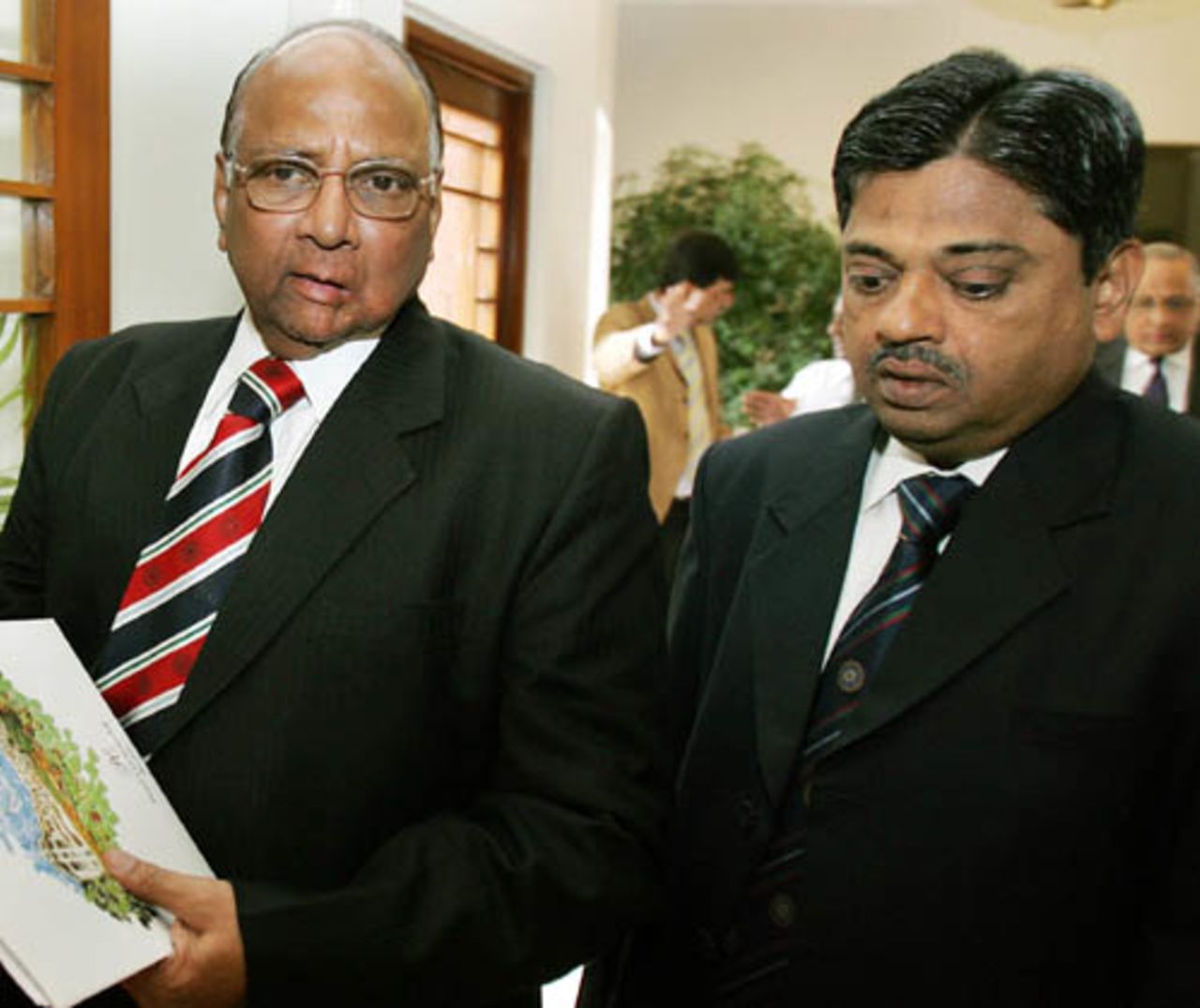 Sharad Pawar talks to Ratnakar Shetty, chief administrative officer of the BCCI, during a meeting at Bhurban, June ,18, 2007