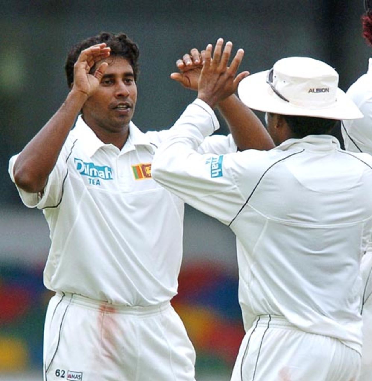 Chaminda Vaas (L) celebrates with his teammates the dismissal of unseen Bangladeshi cricketer Habibul Bashar during the third day of the first Test match between Sri Lanka and Bangladesh at the Sinhalese Sports Club (SSC) grounds in Colombo, 27 June 2007