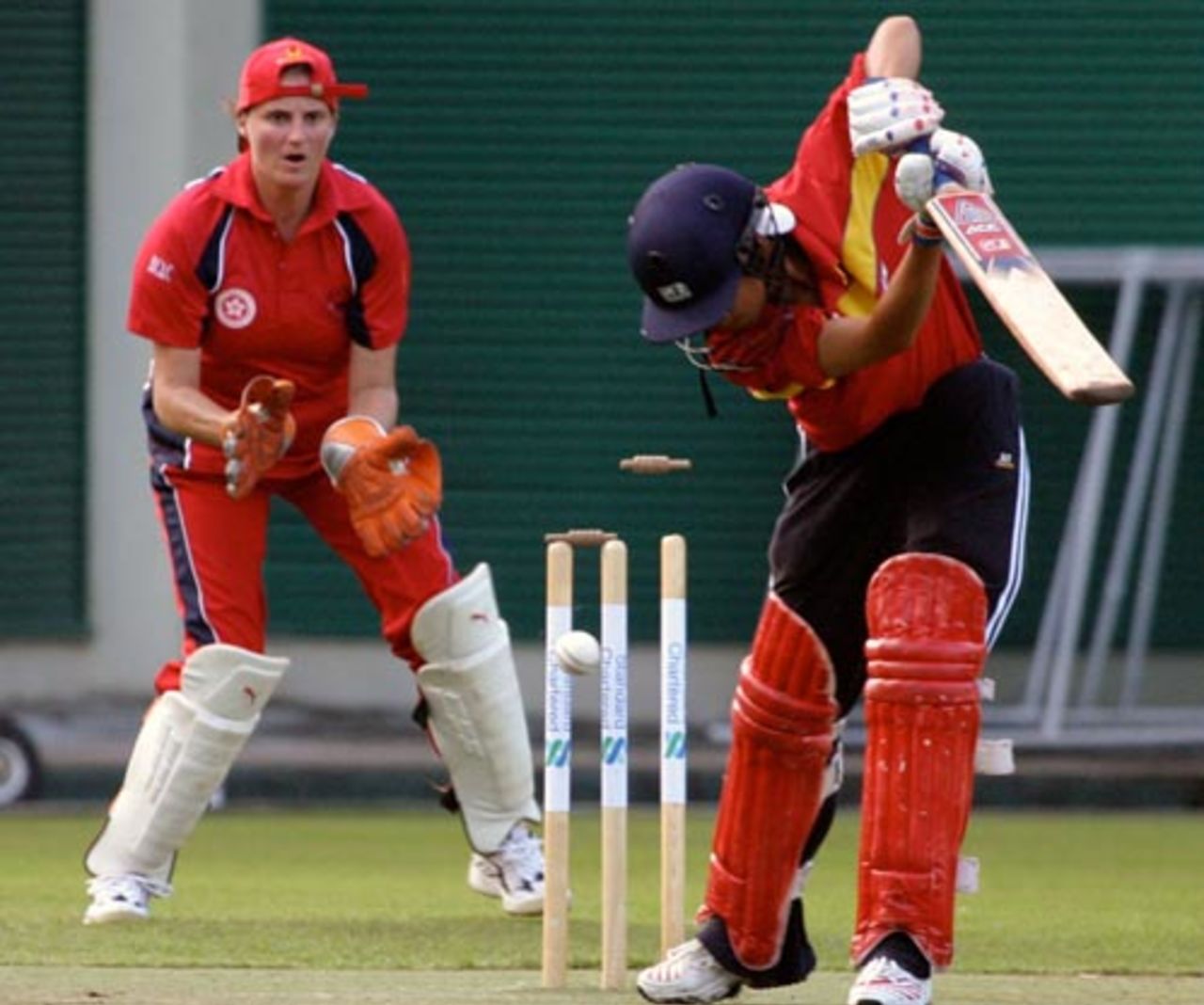 China's Sun Meng Yao is bowled by Ishitaa Gidwani (not in the picture) as Hong Kong wicketkeeper Emma Emma Phillips looks on