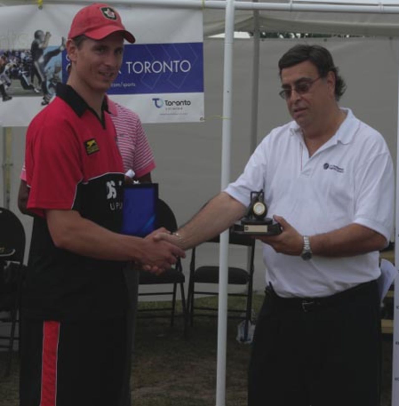 Steve Welsh receives the Man of the Match award from ICC Americas Martin Viera