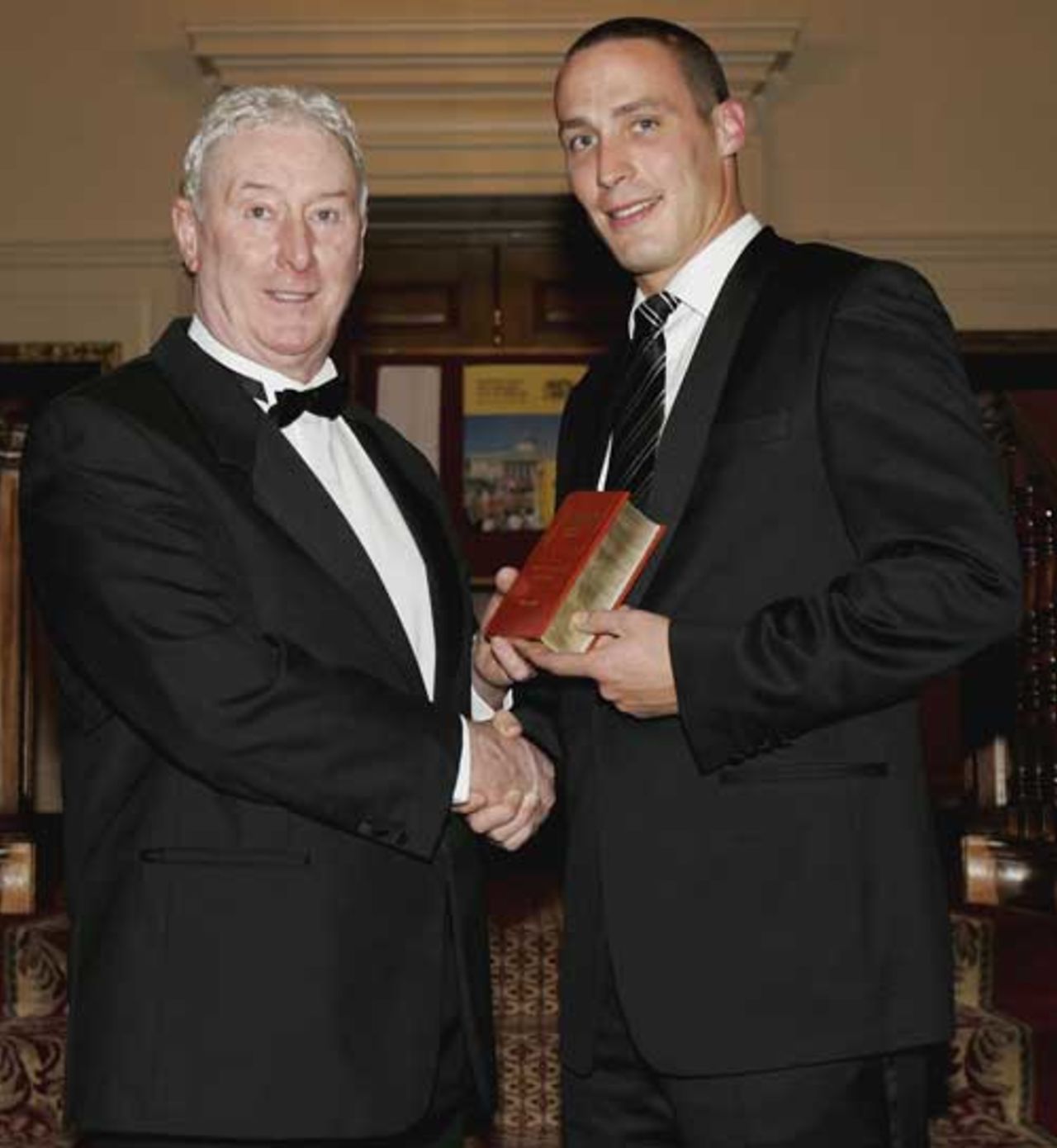 Simon Jones (R) is presented with his Wisden Cricketer of the year award by his father, former England Cricketer Jeff Jones, during the Wisden 2006 launch at the The Inner Temple Hall on April 11, 2006 in London, England.