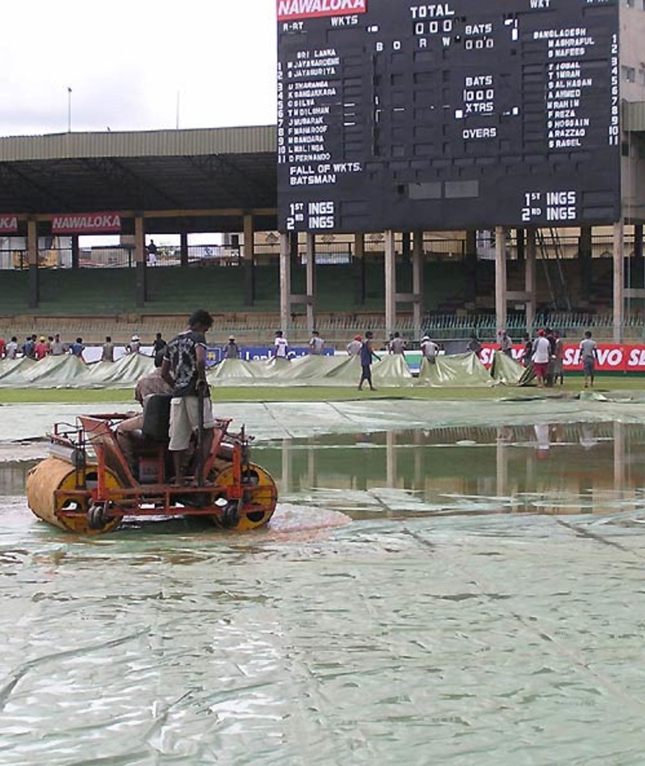 The ground staff at the Premadasa stadium try to clear the wet outfield, Sri Lanka v Bangladesh, 3rd ODI, Colombo, July 25, 2007