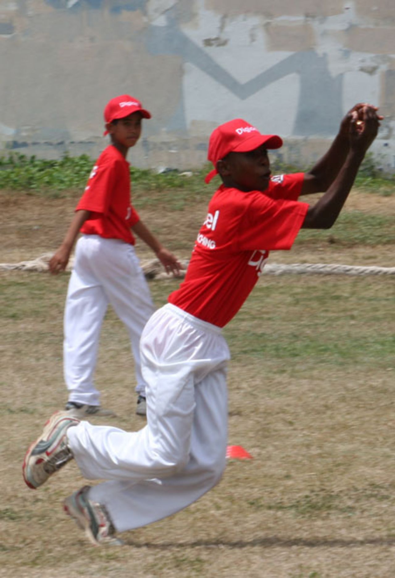Adrian Moulton, an Under-15 cricketer, takes a catch during a coaching session, Jamaica, July 30, 2007