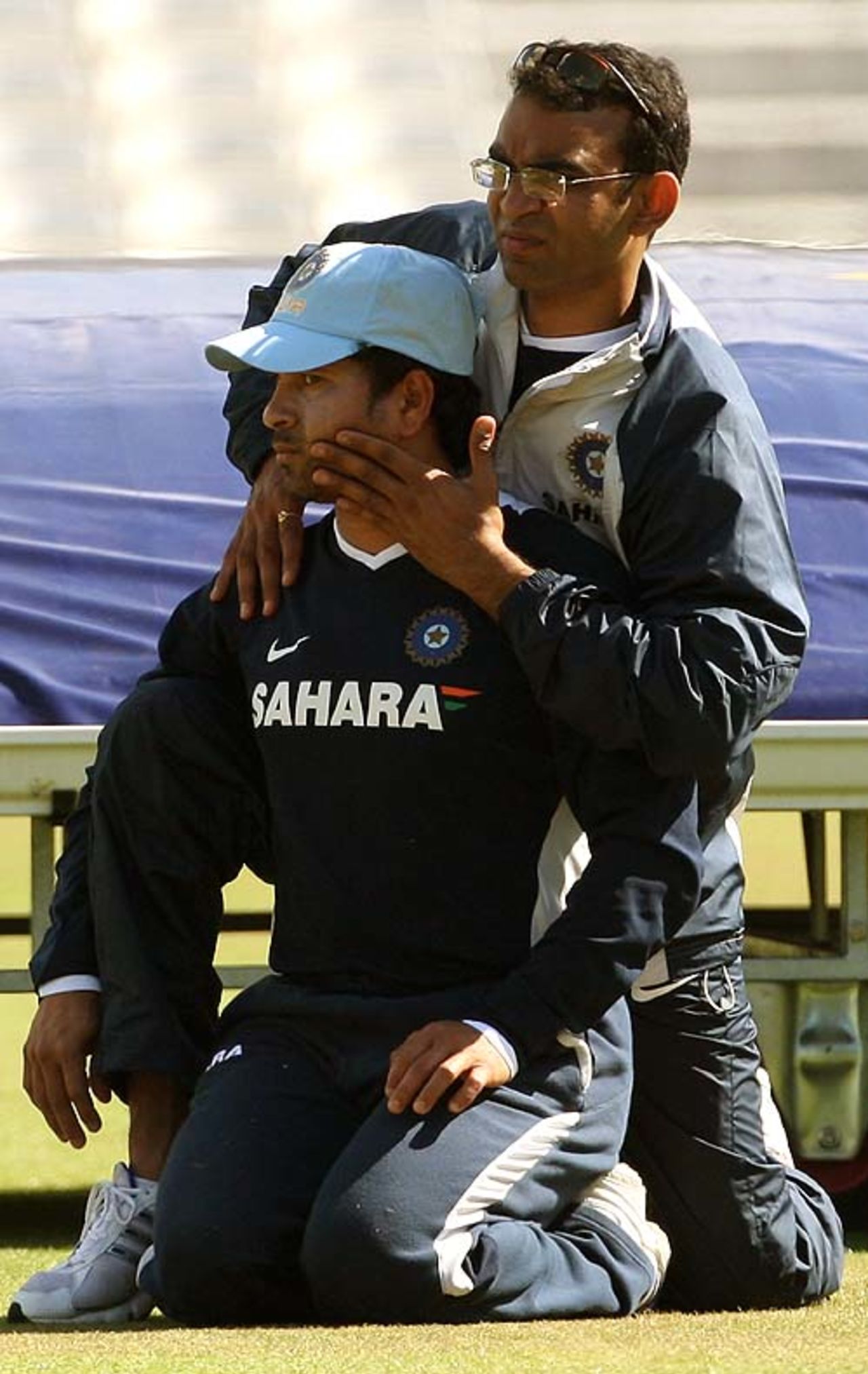 Sachin Tendulkar is assisted with his stretching during a net session ahead of the third Test, The Oval, August 7, 2007