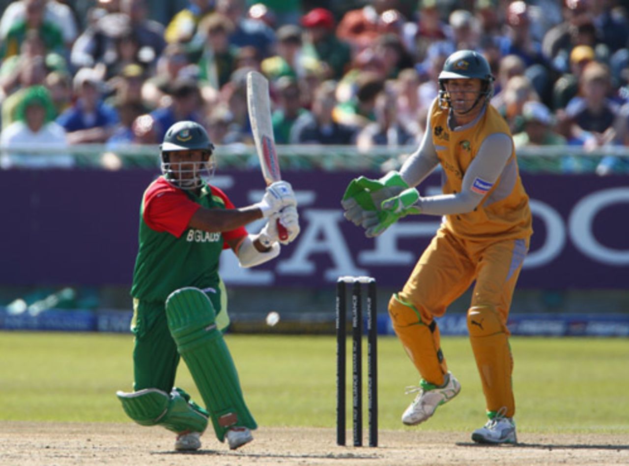 Aftab Ahmed swings the ball through midwicket while Adam Gilchrist looks on, Australia v Bangladesh, Group F, ICC World Twenty20, Cape Town, September 16, 2007