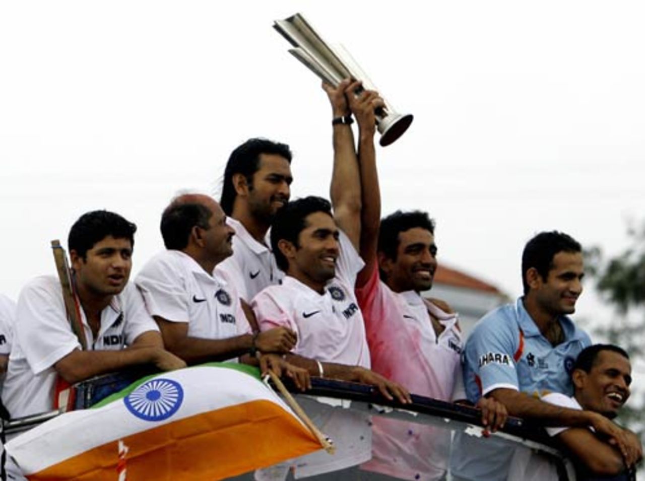 Indian players greet crowds in the streets of Mumbai from atop an open-topped bus, Mumbai, September 26, 2007