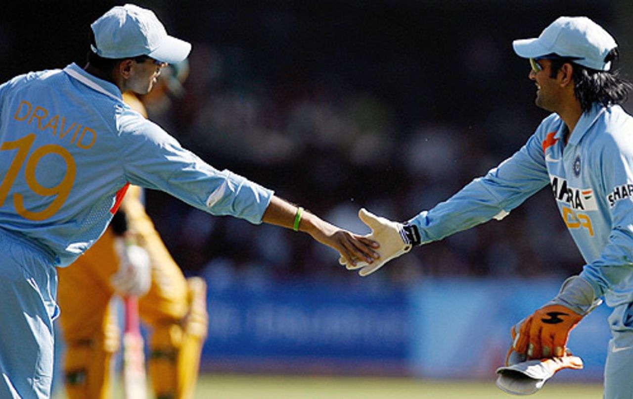 <i>Creation of Adam</i>? Rahul Dravid and Mahendra Singh Dhoni celebrate a wicket, India v Australia, 1st ODI, Bangalore, September 29, 2007


