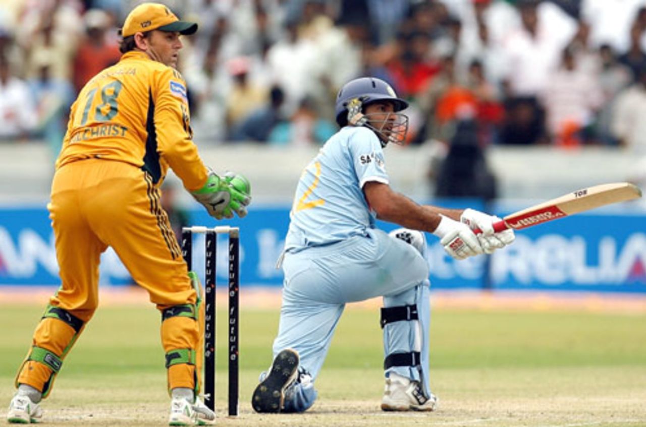 Yuvraj Singh sweeps the ball square while Adam Gilchrist looks on, India v Australia, 3rd ODI, Hyderabad, October 5, 2007