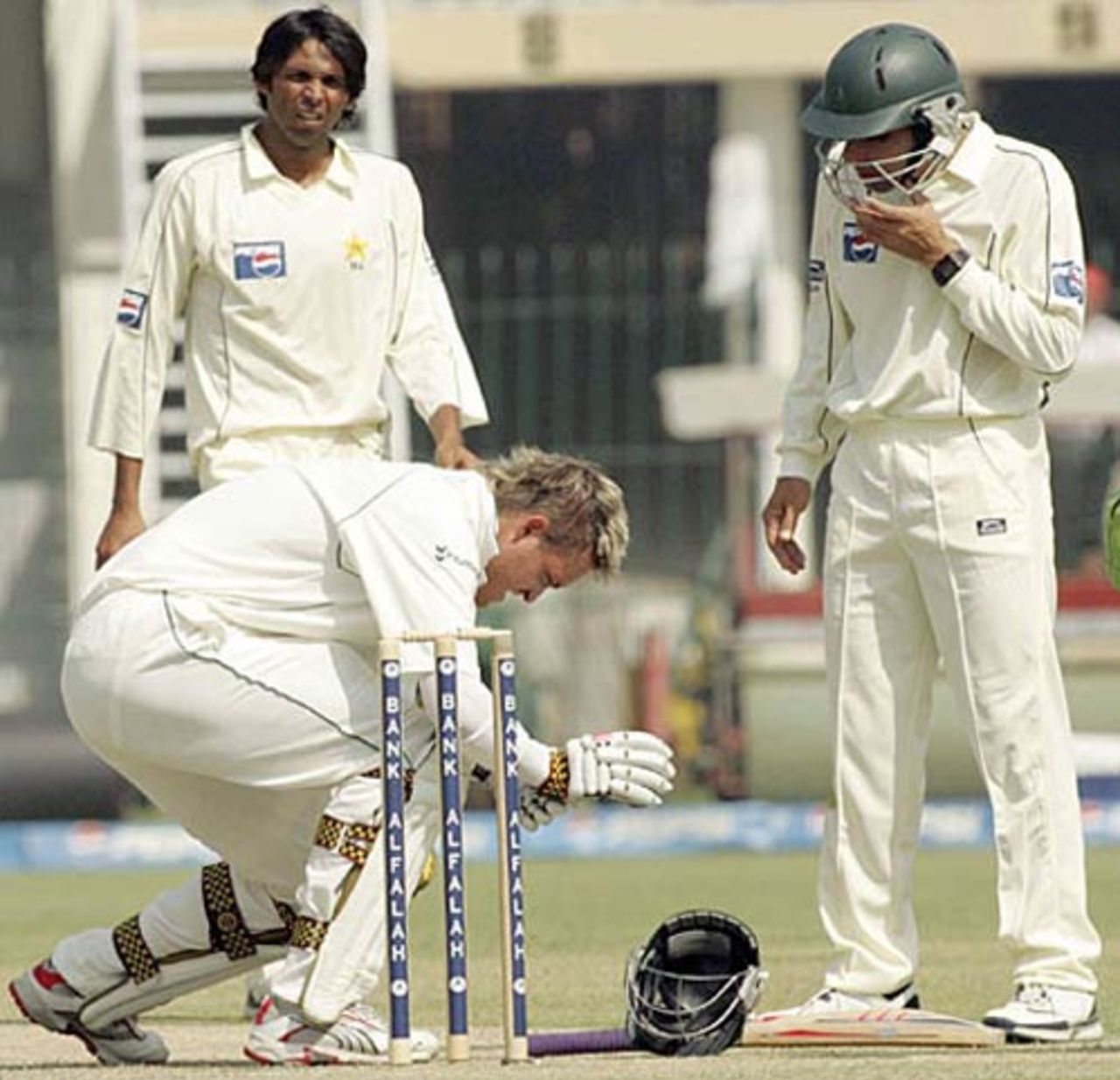 Mohammad Asif and Misbah-ul-Haq watch as Paul Harris gets up after been hit on the head, Pakistan v South Africa, 2nd Test, Lahore, 2nd day, 