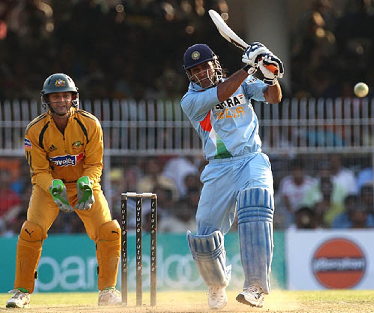 Mahendra Singh Dhoni blasts one straight while Adam Gilchrist looks on, India v Australia, 6th ODI, Nagpur, October 14, 2007   



