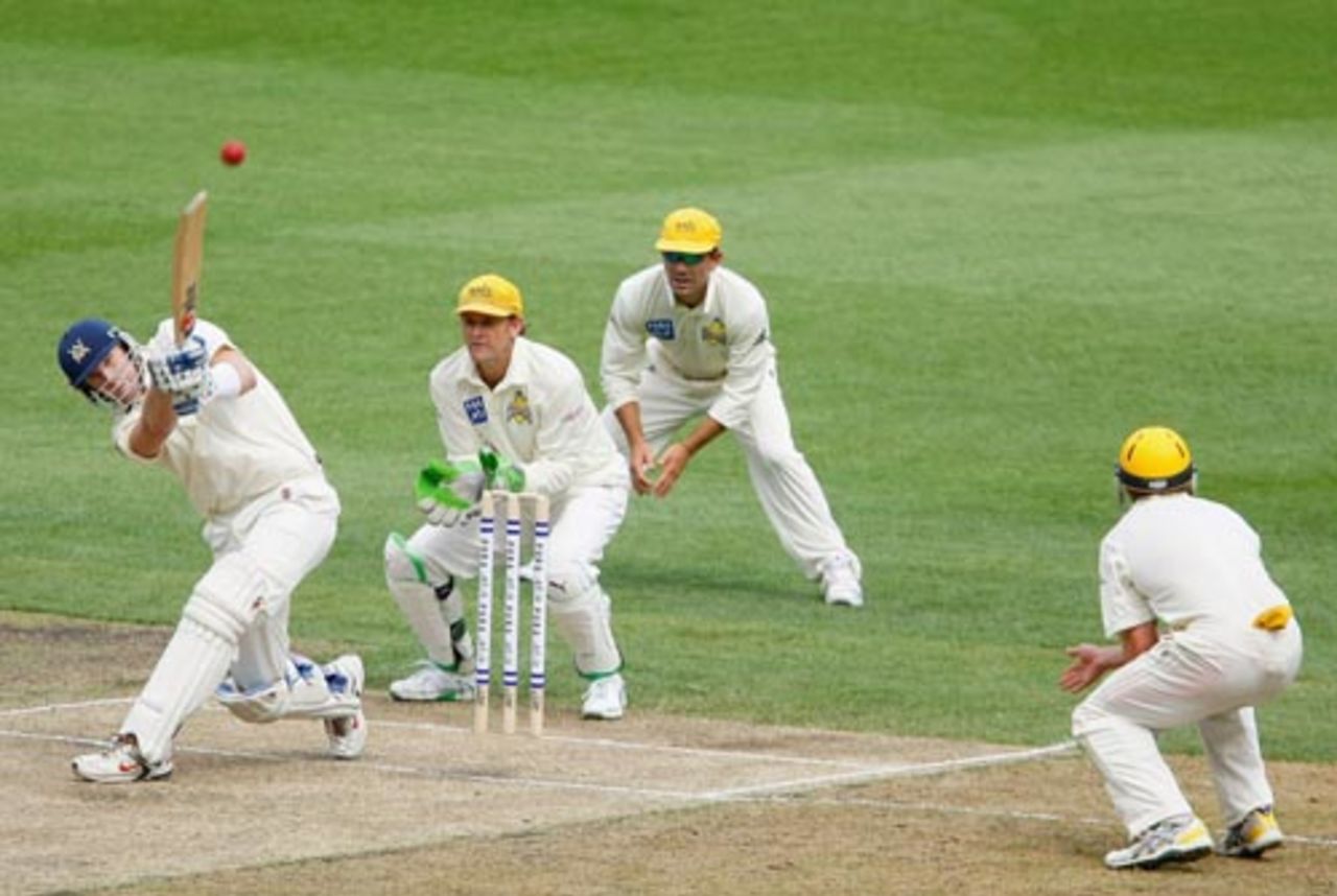 Cameron White heaves the ball to the mid-wicket boundary as Adam Gilchrist and Justin Langer look on, Victoria v Western Australia, Pura Cup, Melbourne, 2nd day, October 27, 2007 