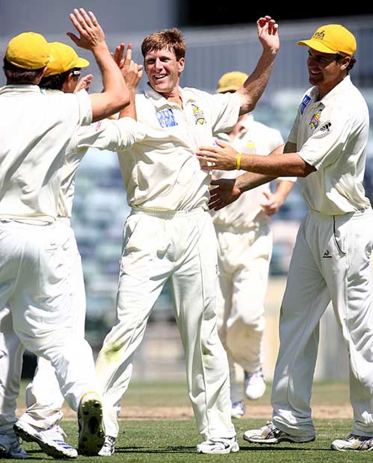 Mathew Inness is congratulated by team-mates after he took the wicket of Queensland's Clinton Perren, Western Australia v Queensland, Pura Cup, 1st day, November 9, 2007
