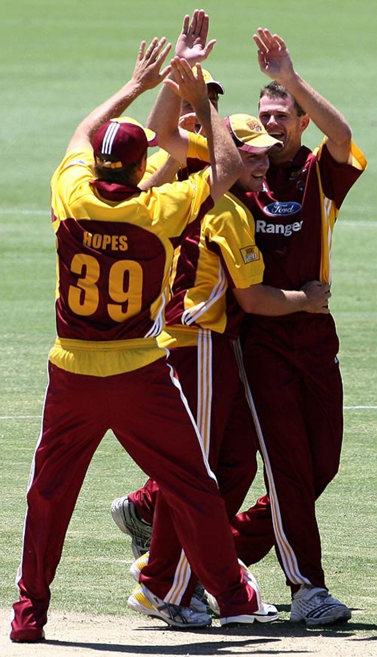 Chris Swan's team-mates congratulate him on one of his four wickets on debut, Western Australia v Queensland, FR Cup, Perth, November 14, 2007