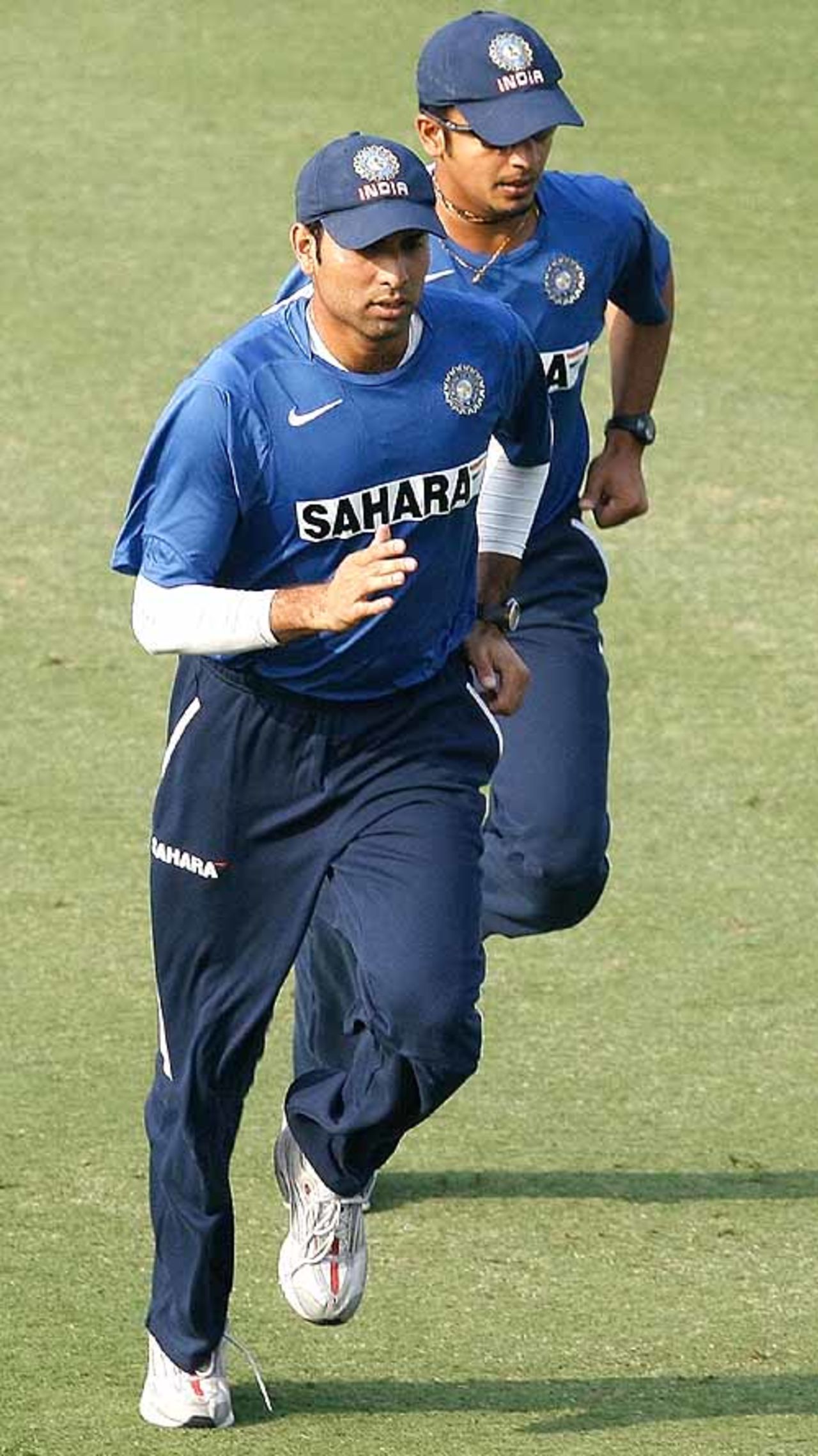 VVS Laxman and Murali Kartik have a run at the Feroz Shah Kotla, Delhi, November 20, 2007
