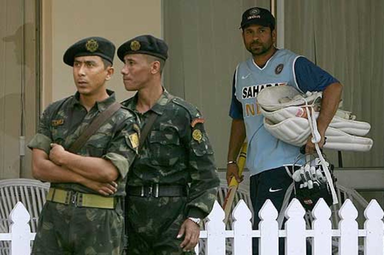Sachin Tendulkar looks on as security personnel guard India's training session, Kolkata, November 28, 2007