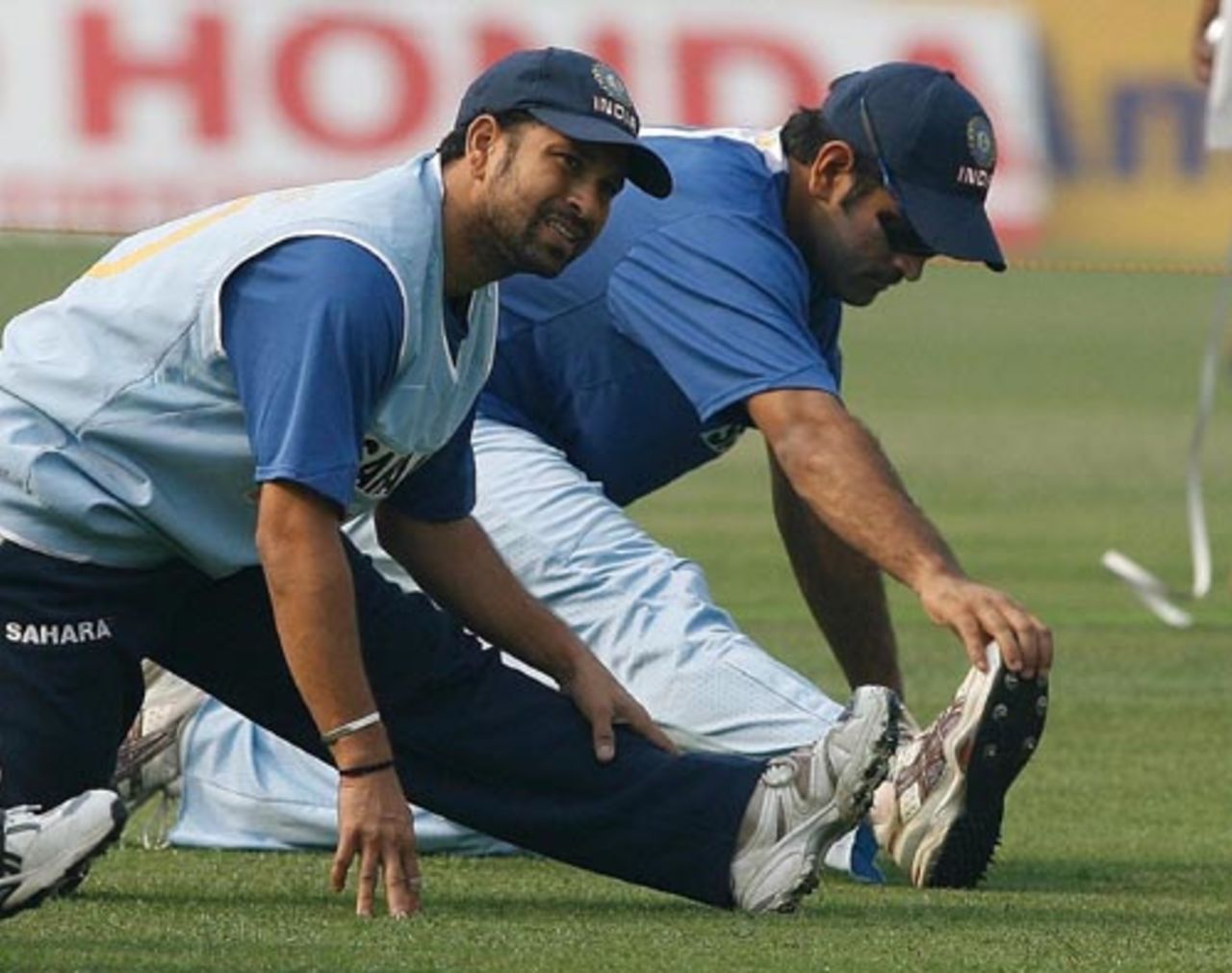 Sachin Tendulkar and Mahendra Singh Dhoni stretch during a warm-up session, Kolkata, November 29, 2007 