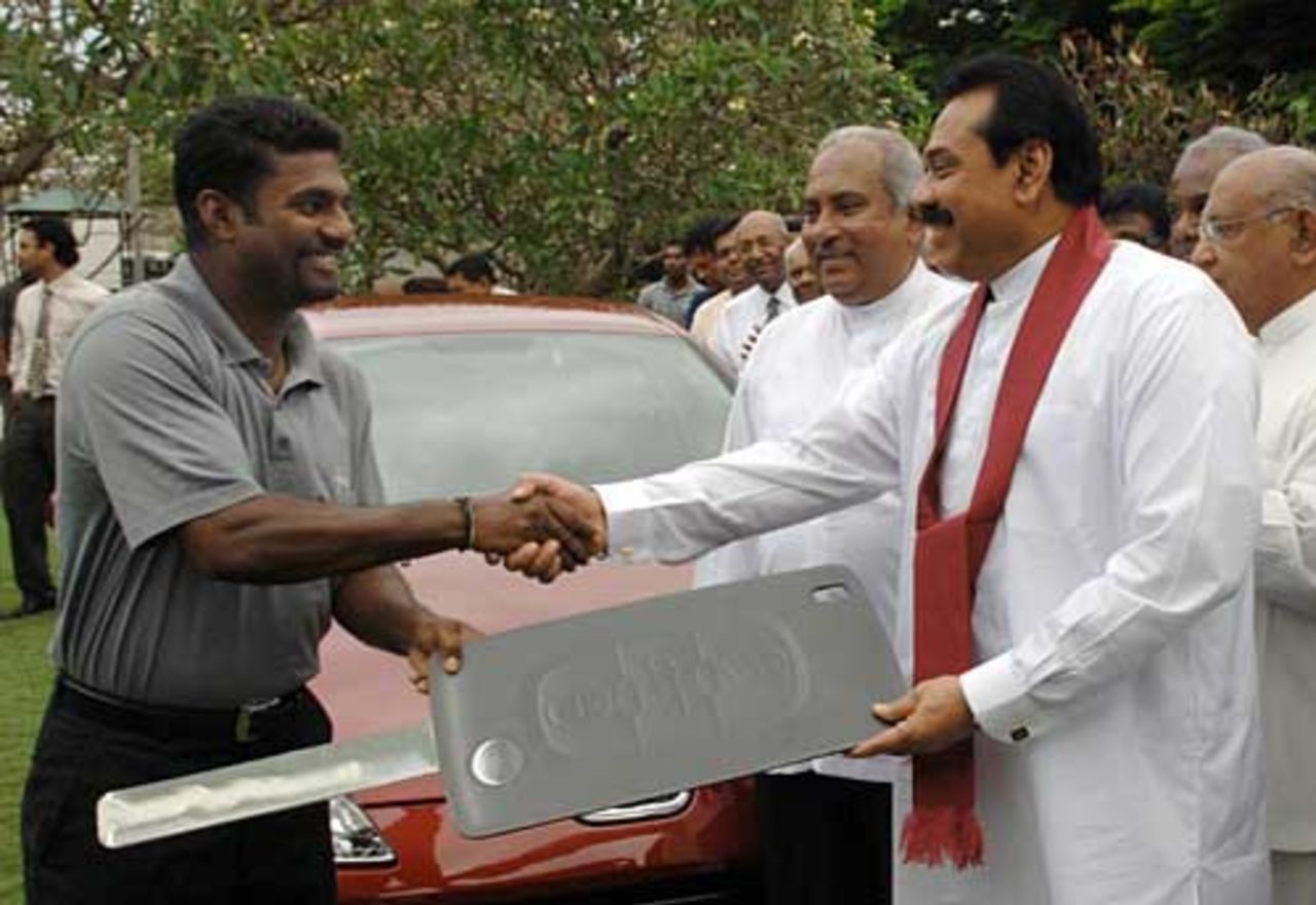 Muttiah Muralitharan is presented with the keys to a new car by Sri Lanka President Mahinda Rajapakse, Colombo, December 7, 2007
