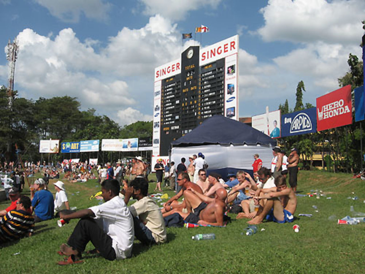 Fans relax on the grass embankment near the giant scoreboard, Sri Lanka v England, 2nd Test, Colombo, 2nd day, December 10, 2007