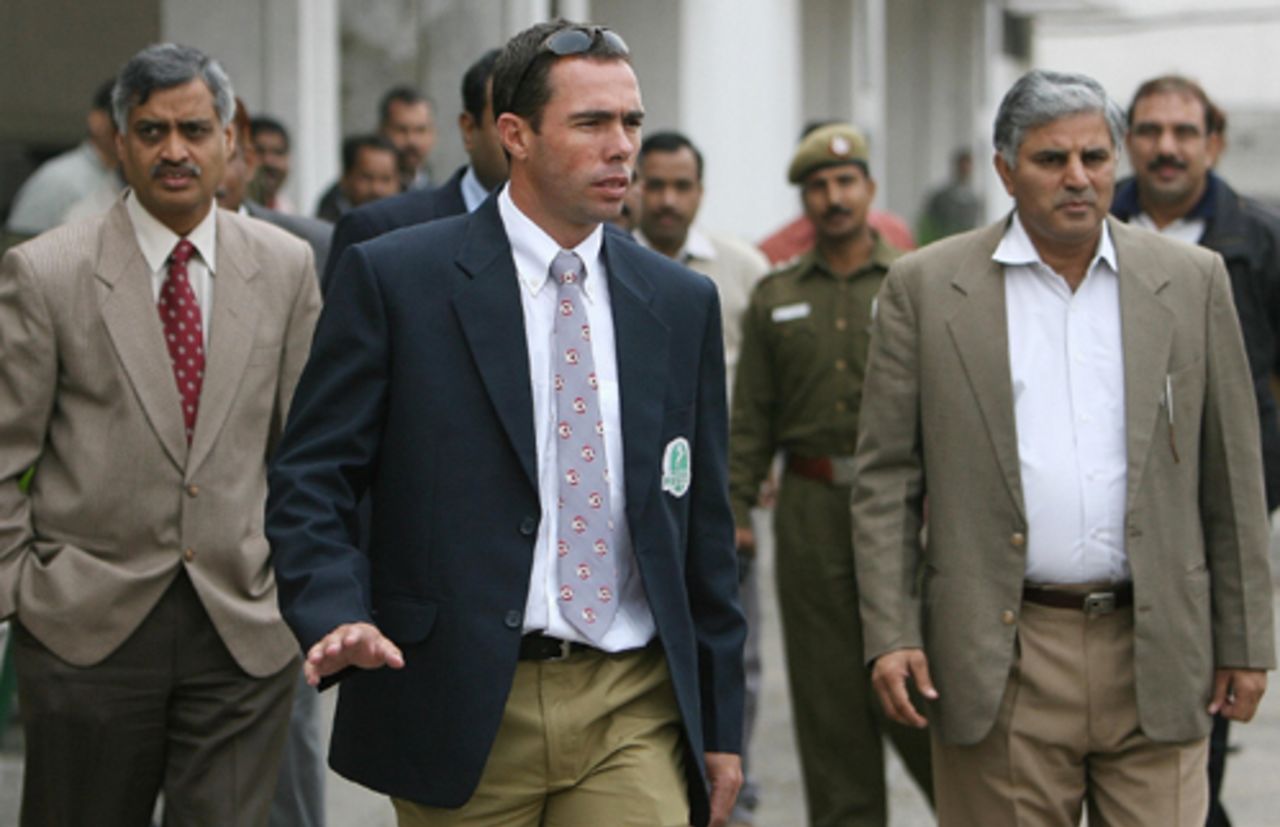 Nicky Boje is escorted by Delhi police officials after being questioned over the 2000 match-fixing scandal, Delhi, December 11, 2007 