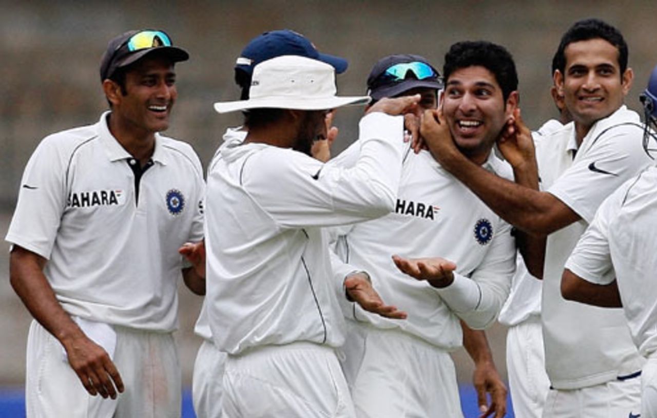Yuvraj Singh is congratulated by his team-mates after taking the wicket of Yasir Arafat, India v Pakistan, 3rd Test, Bangalore, 5th day, December 12, 2007 

