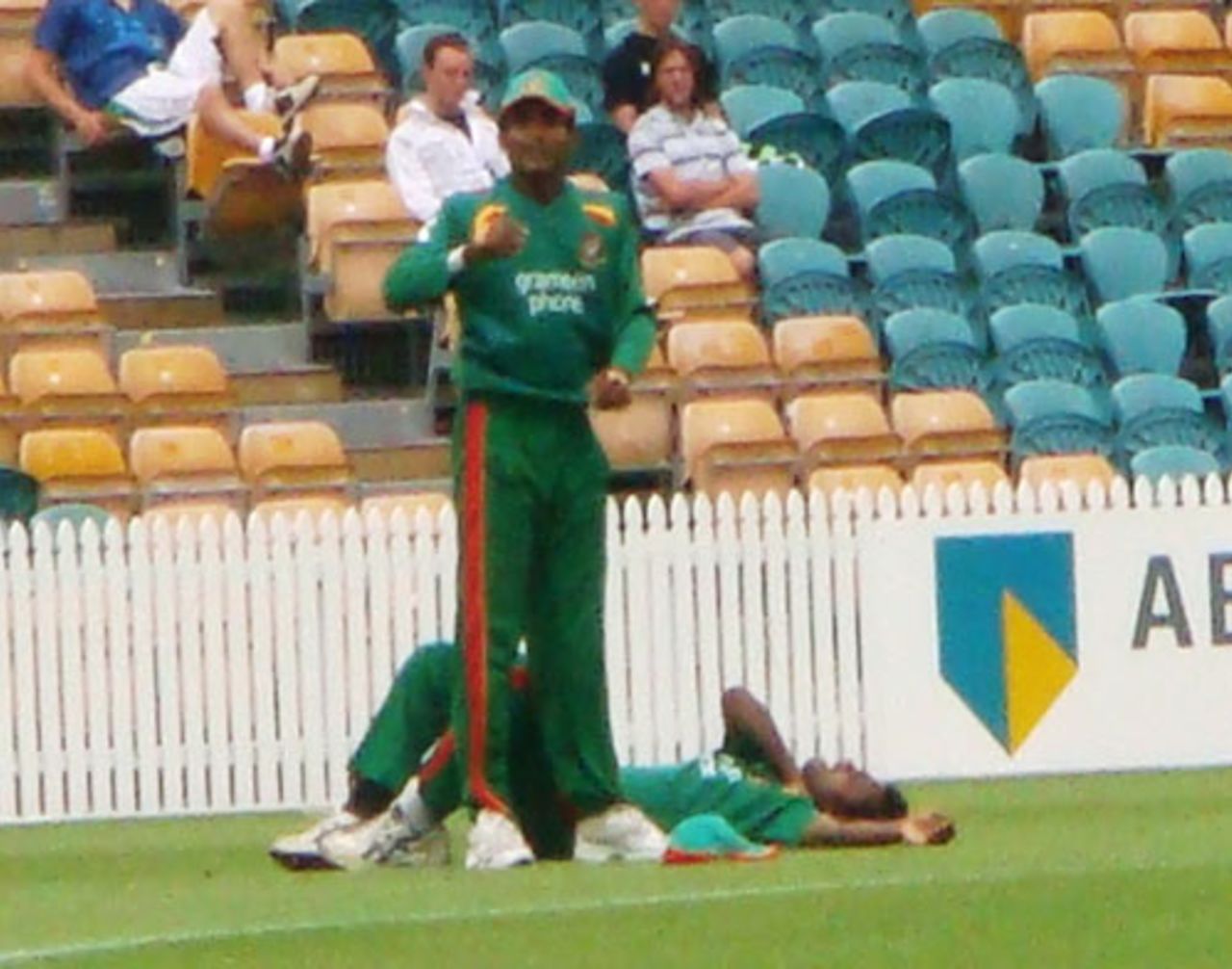 Junaid Siddique signals to the physio after Syed Rasel dislocated his left collar bone while fielding, Northern Districts v Bangladesh, Tour Match, Hamilton, December 16, 2007 
