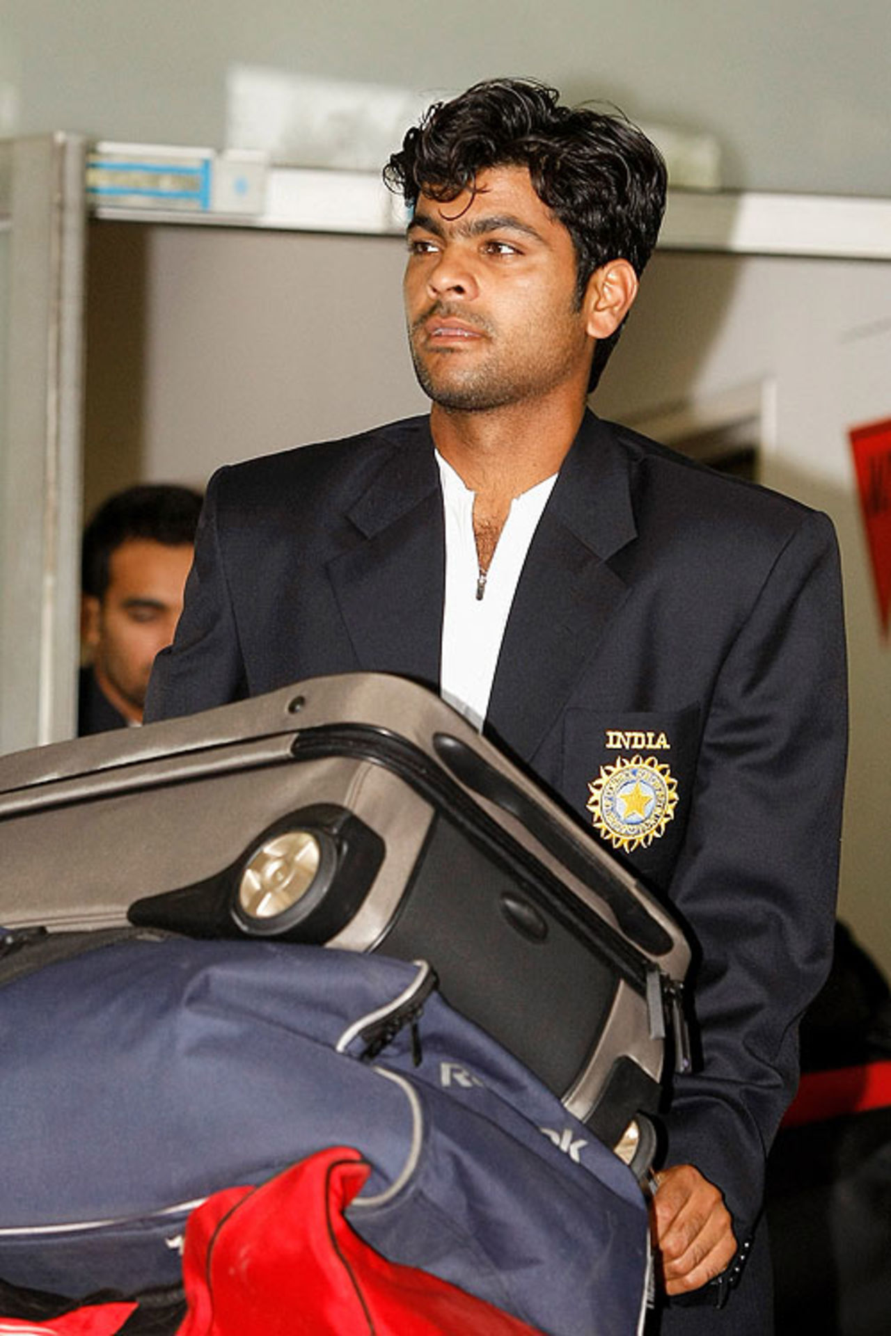 RP Singh collects his bags and heads towards the exit at Melbourne Airport, Melbourne, December 18, 2007