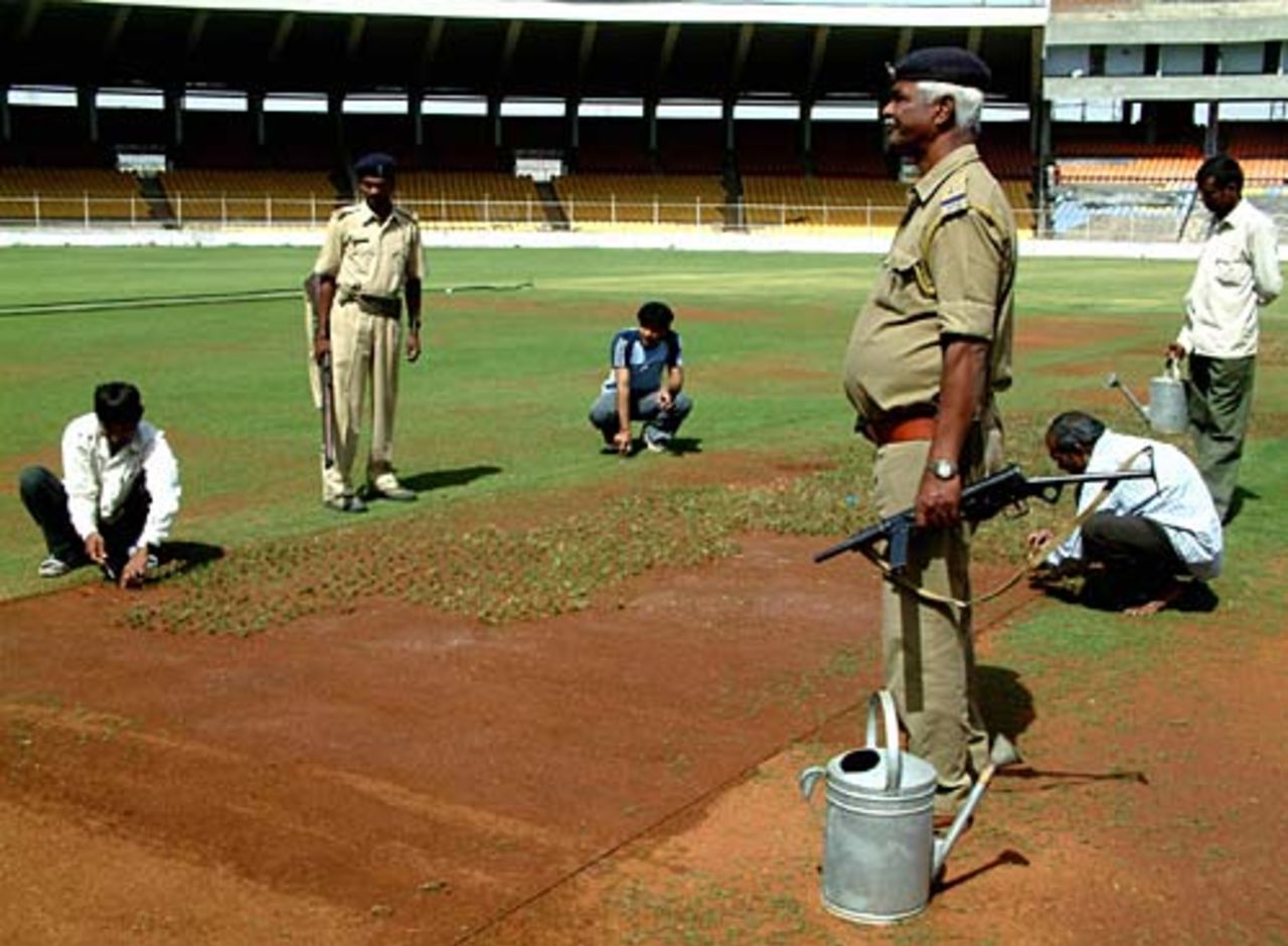 Indian workers prepare the main pitch at the Motera Stadium, Ahmedabad, February 18, 2005