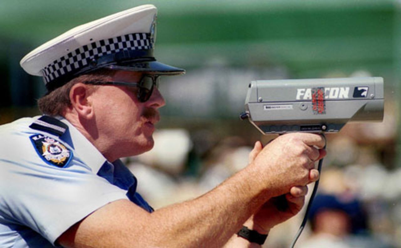 A Western Australian policeman aims his speed-radar gun at the wicket trying to determine the speed of Shoaib Ahktar, Western Australia v Pakistan, Perth, October 27, 1999
