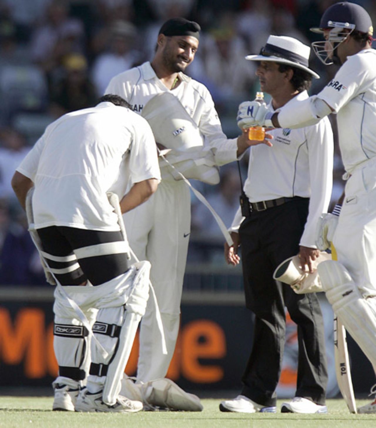 Asad Rauf keeps a close watch on proceedings while Mahendra Singh Dhoni changes his thigh pad, Australia v India, 3rd Test, 1st day, Perth, January 16, 2008 