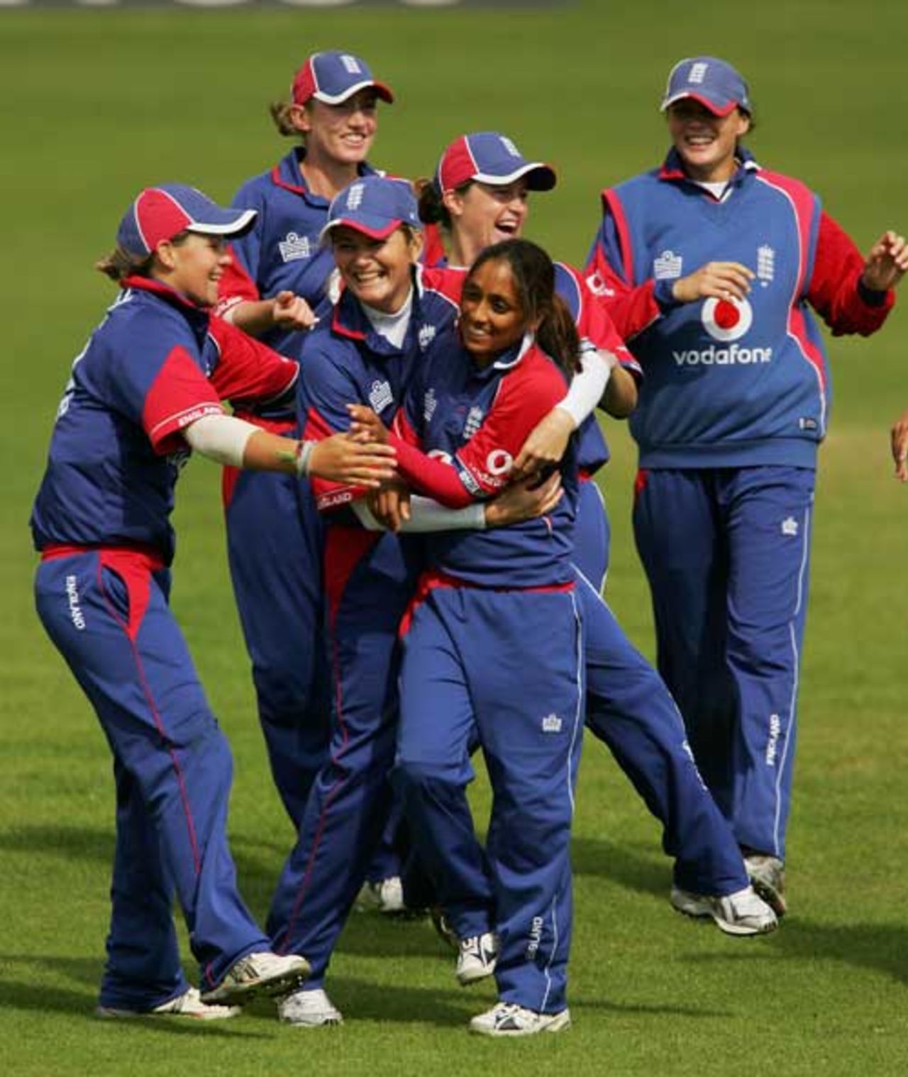 Isa Guha of England is congratulated by Charlotte Edwards, after bowling Nicola Browne of New Zealand during the fifth one-day International match between England and New Zealand at Blackpool Cricket Club