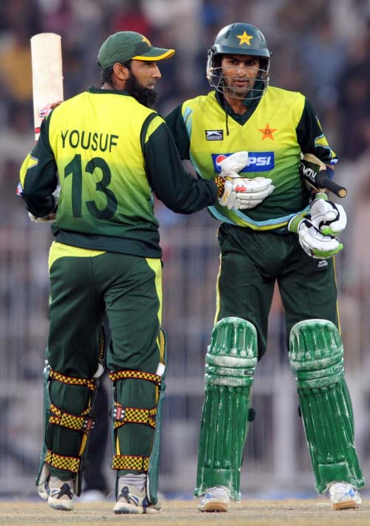Shoaib Malik is congratulated by Mohammad Yousuf on reaching fifty, Pakistan v Zimbabwe, 4th ODI, Mobilink Cup, Faisalabad, January 30, 2008