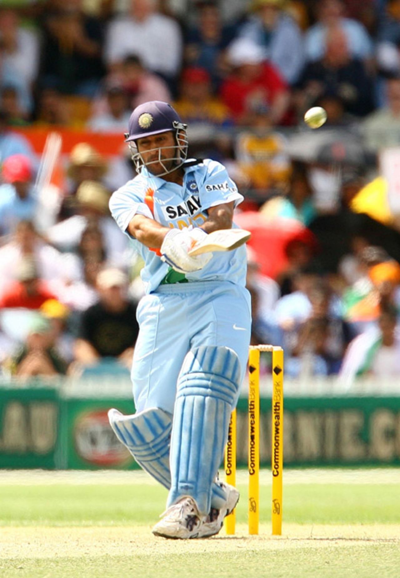Mahendra Singh Dhoni plays his version of the double-fisted forehand, India v Sri Lanka, CB Series, 5th ODI, Canberra, February 12, 2008 
