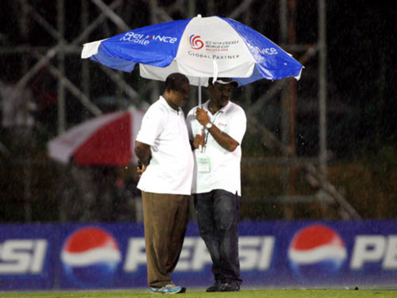 Officials take cover while inspecting the outfield, Pakistan v South Africa, 2nd semi-final, Under-19 World Cup, Kuala Lumpur, February 29, 2008 