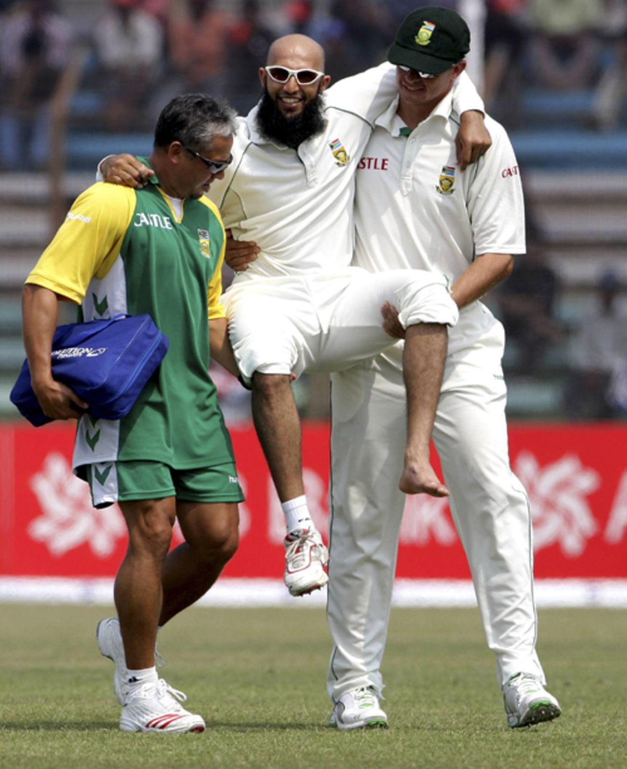 Hashim Amla is carried off the field by physio Shane Jabbar and Andre Nel after he injured his foot, Bangladesh v South Africa, 2nd Test, Chittagong, 3rd day, March 2, 2008 

