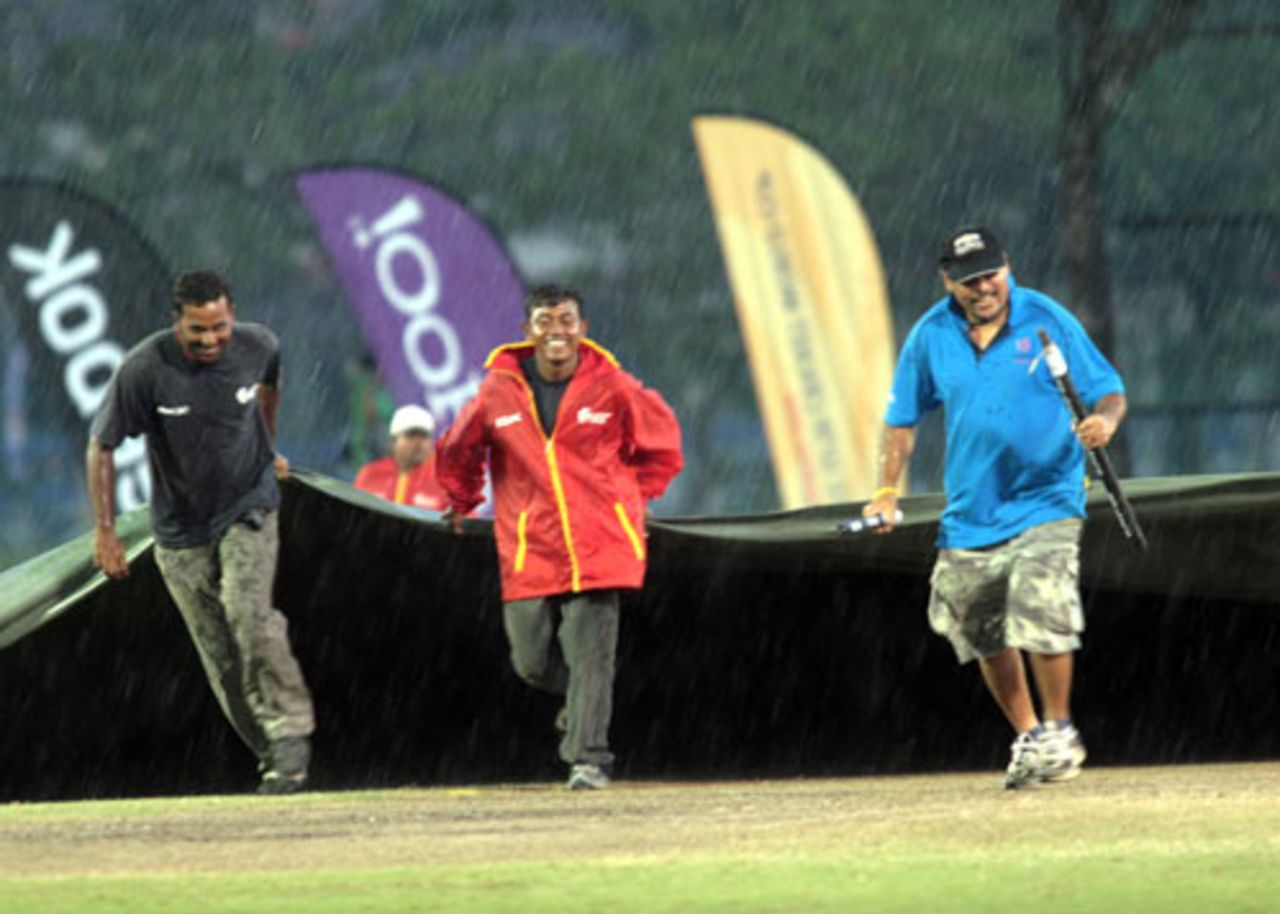 The ground staff rush out with the covers, India v South Africa, Under-19 World Cup final, Kuala Lumpur, March 2, 2008 
