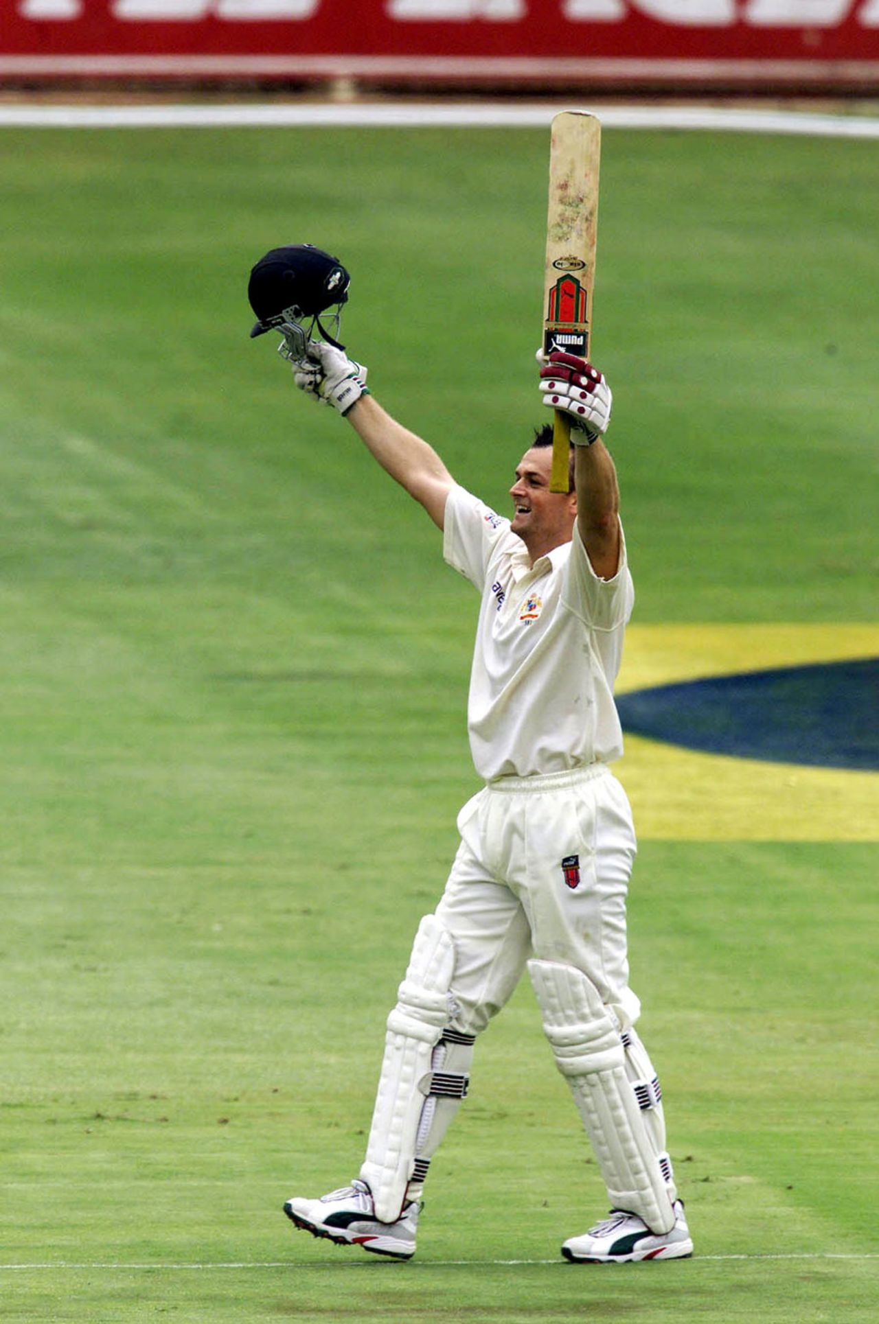 Adam Gilchrist celebrates his century during the second day of the first Test against South Africa at The Wanderers, Johannesburg