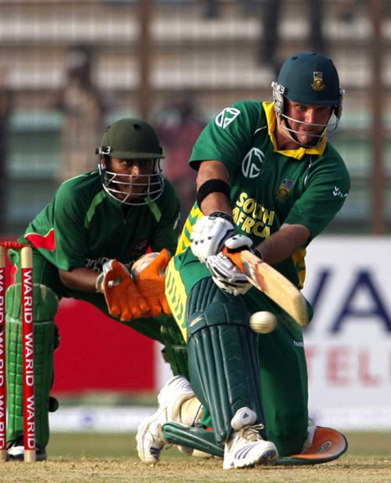 Graeme Smith attempts the sweep shot as Dhiman Ghosh looks on, Bangladesh v South Africa, 1st ODI, Chittagong, March 9, 2008