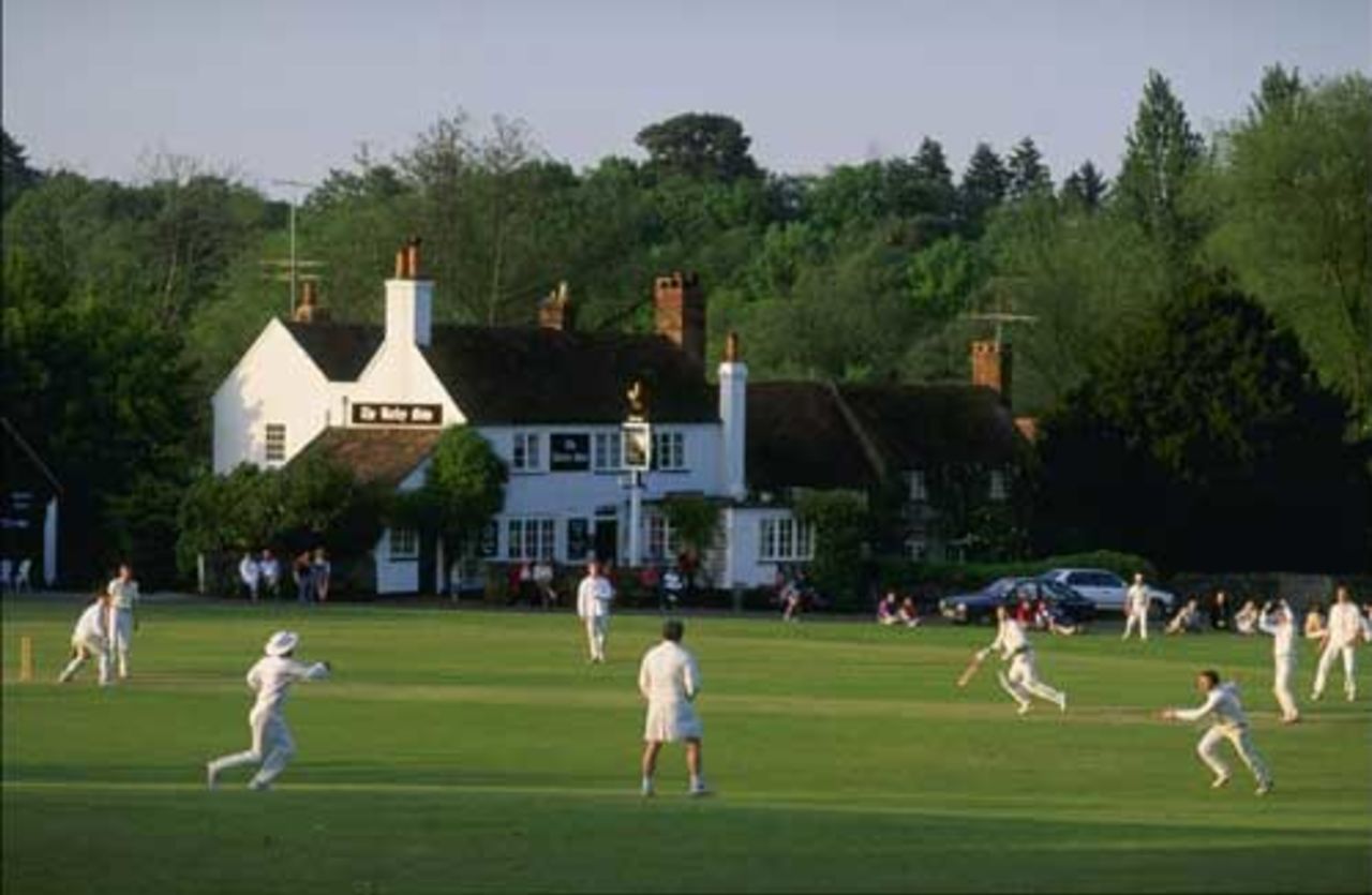 A village cricket match in progress at Tilford in Surrey, 1994