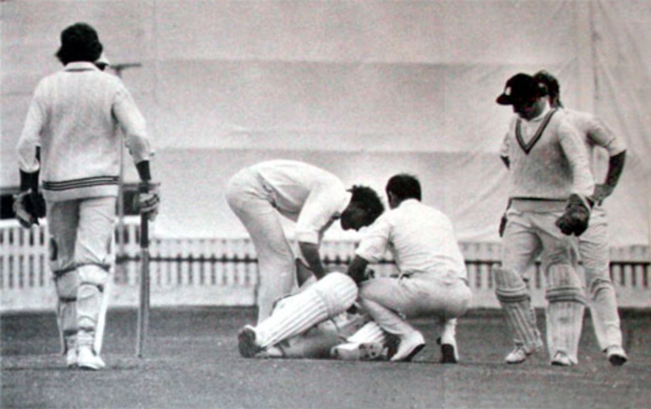 Mike Denness and John Edrich tend to the prone Ewen Chatfield, New Zealand v England, 1st Test, Auckland, February 24, 1975