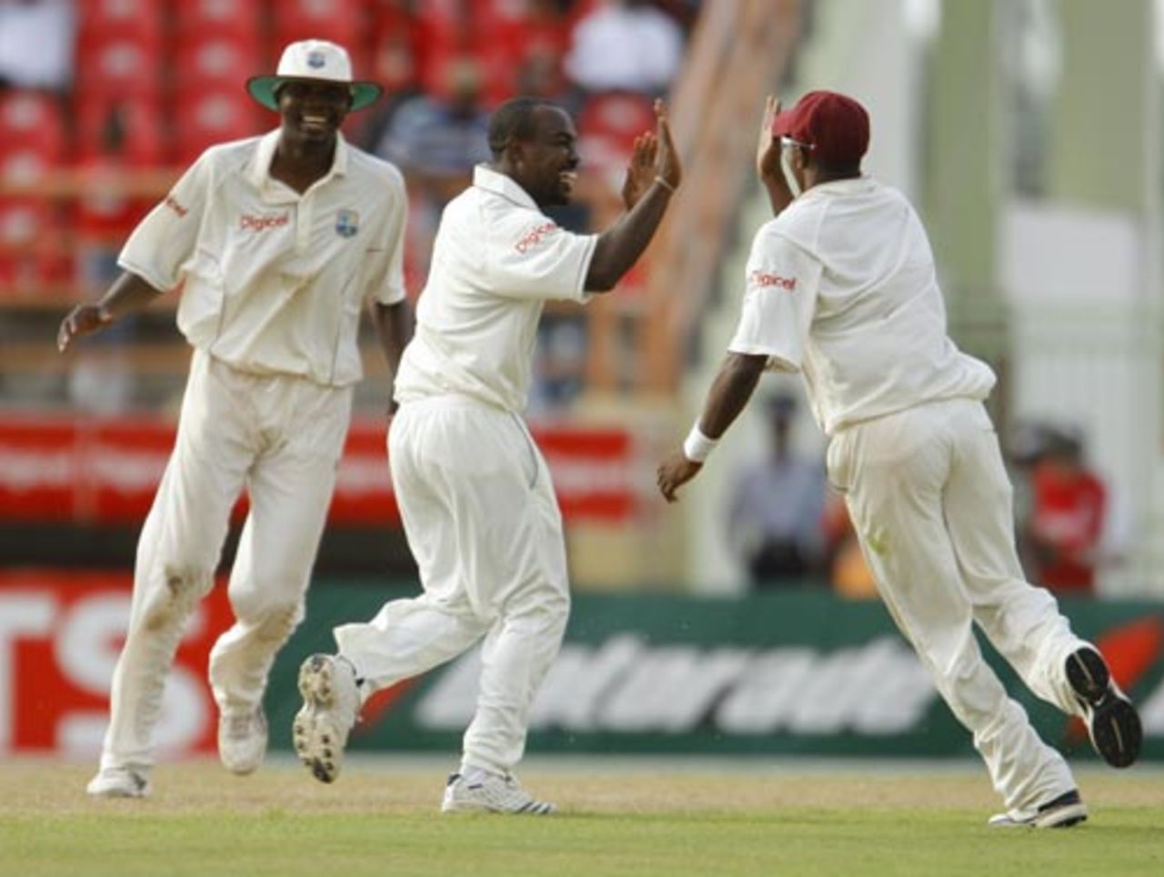 Travis Dowlin watches Sulieman Benn and Dwayne Bravo exchange high fives, West Indies v Sri Lanka, 1st Test, Guyana, 1st day, March 22, 2008