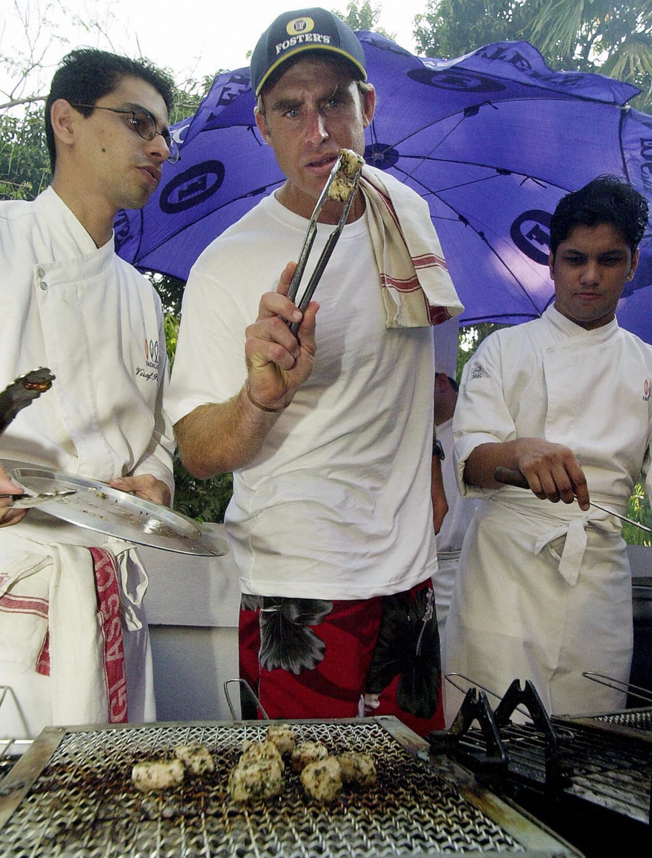 Matthew Hayden grills chicken at a sponsor's party in Mumbai