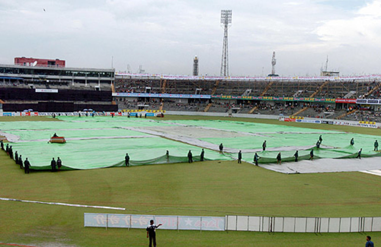 The pitch and outfield were kept under wraps as showers delayed the start of play, Bangladesh v Pakistan, 1st match, Kitply Cup, Mirpur, June 8, 2008