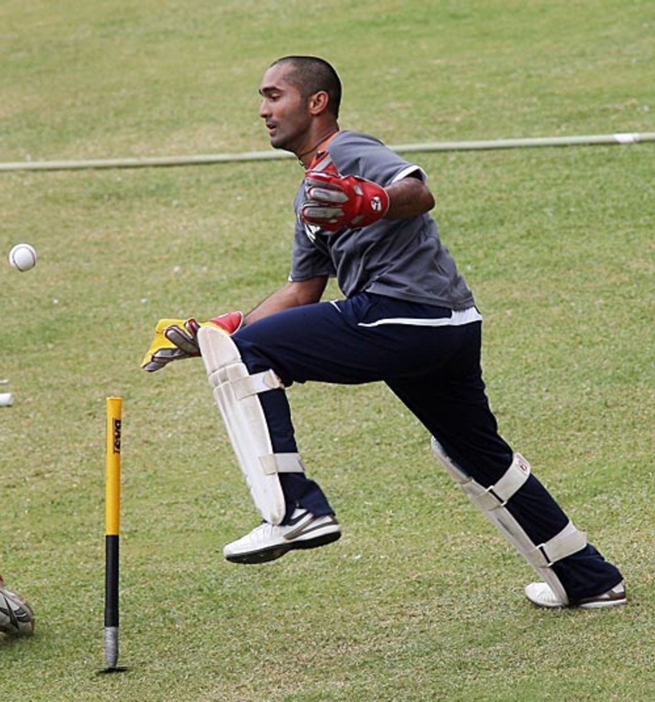 Dinesh Karthik collects the ball during a training camp at the Chinnaswamy Stadium, Bangalore, June 24, 2008