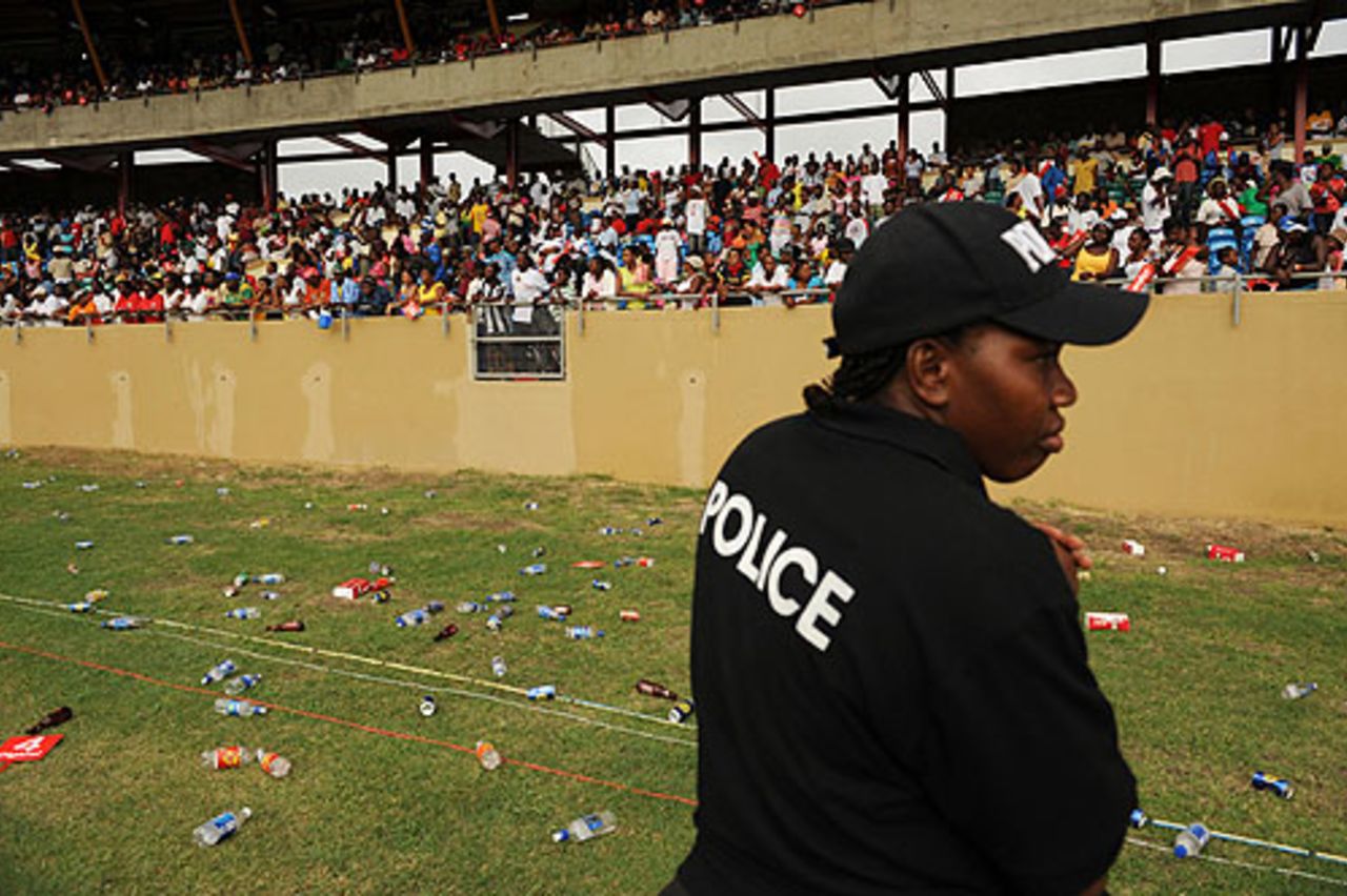 A police officer watches on as the crowd throw bottles and cans onto the field, West Indies v Australia, 1st ODI, St Vincent, June 24, 2008