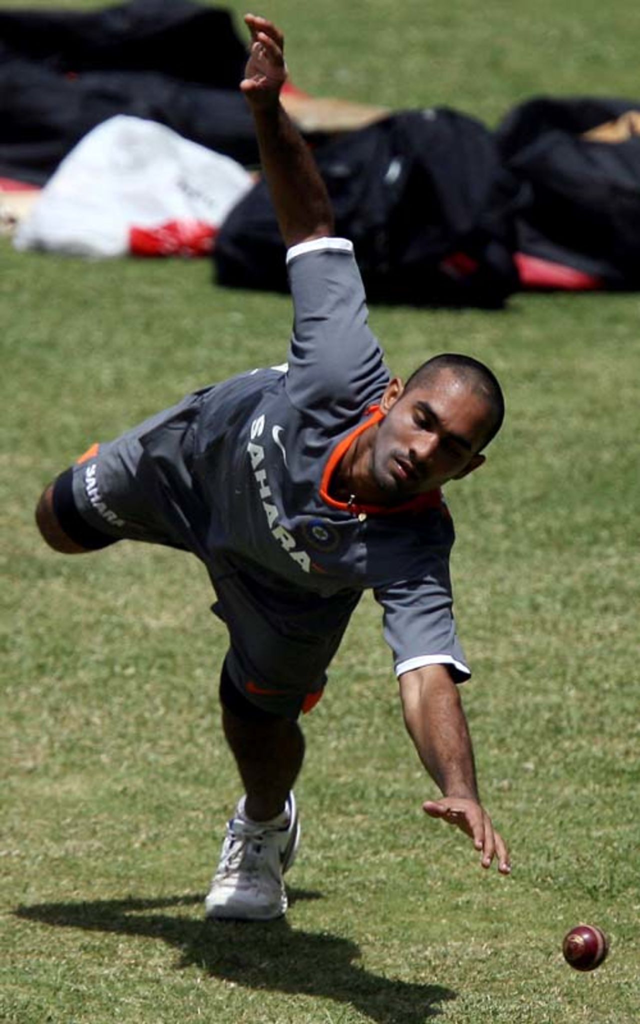 Dinesh Karthik reaches out for the ball during the camp conducted by the National Cricket Academy, Bangalore, June 26, 2008
