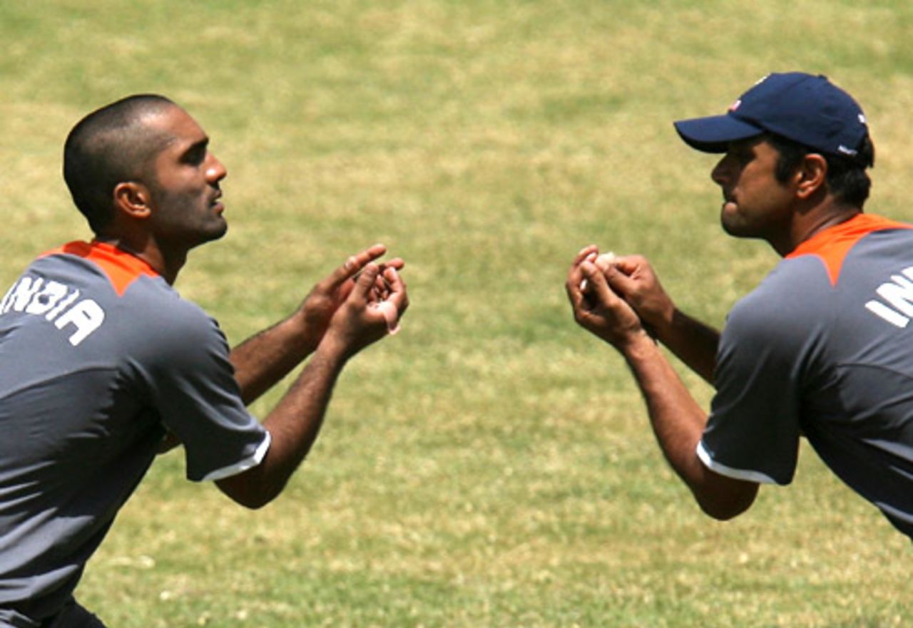 Synchronised simulation: Dinesh Karthik and Rahul Dravid do the catching routine, Bangalore, June 26, 2008