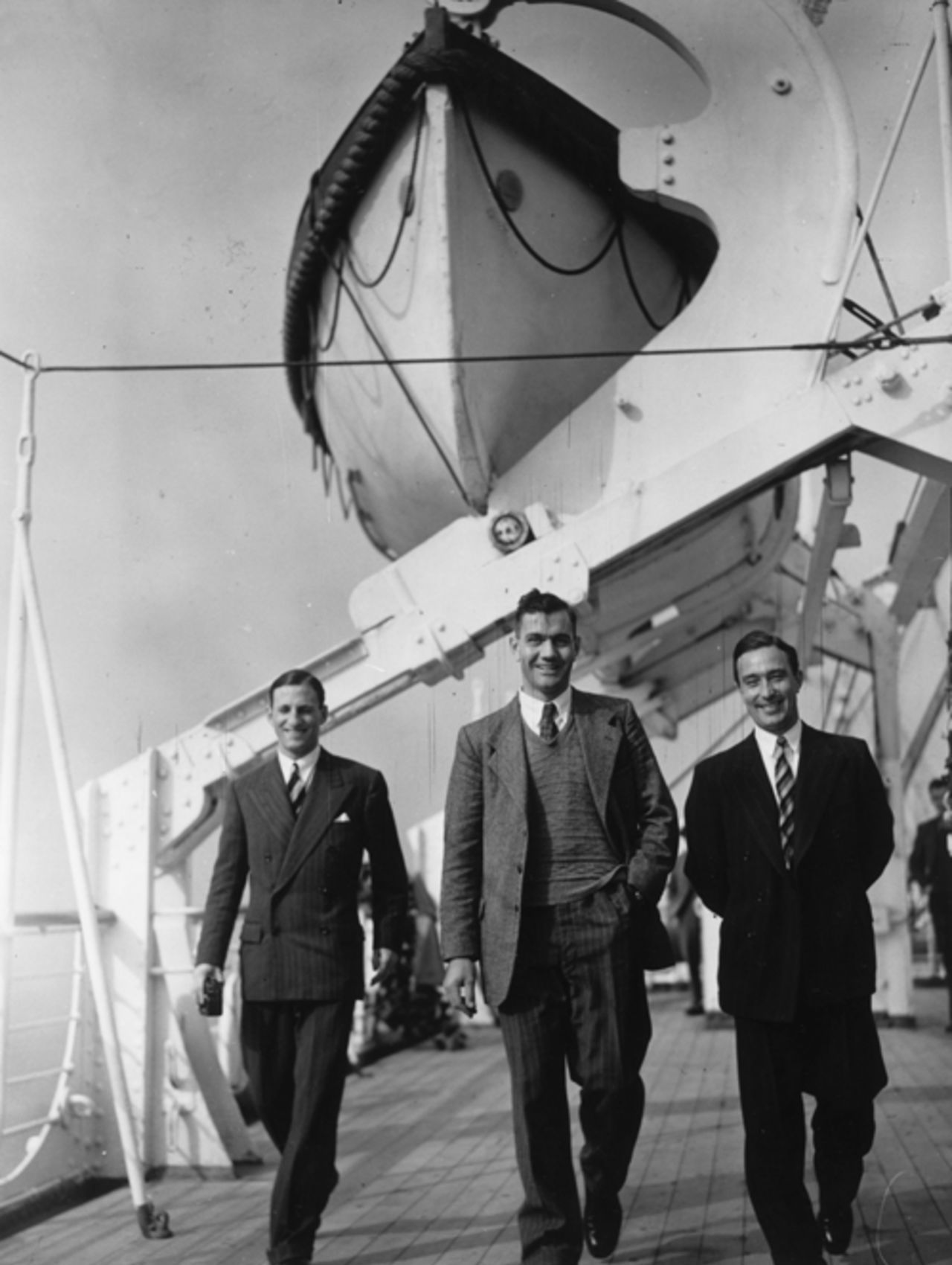 Len Hutton, Alec Bedser, and Denis Compton walking on deck on the <I>Dublin Castle</I> prior to departure for South Africa, October 7, 1948